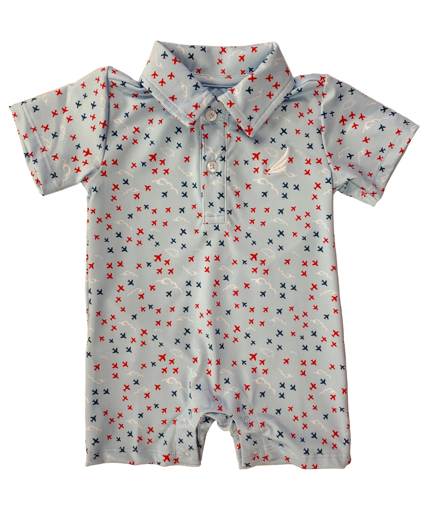 Baby romper with airplane pattern on a beige background