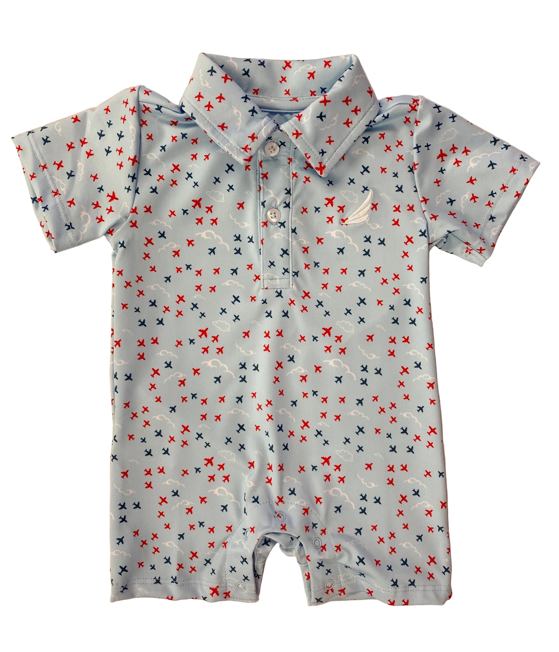 Baby romper with airplane pattern on a beige background
