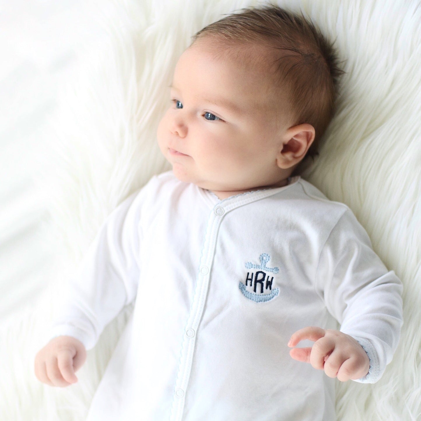 White with baby blue trim footie with anchor monogram